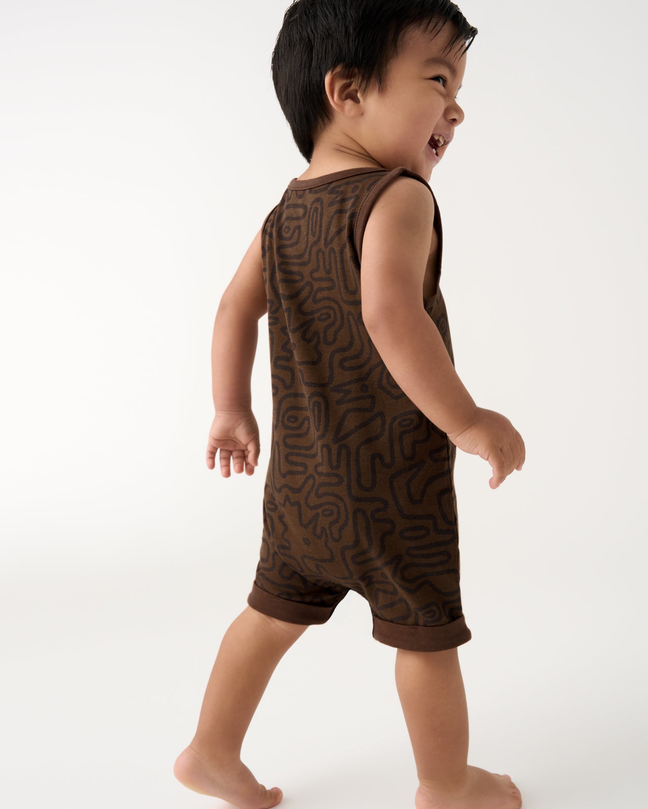 Back view of toddler wearing the Dino Maze Henley Romper