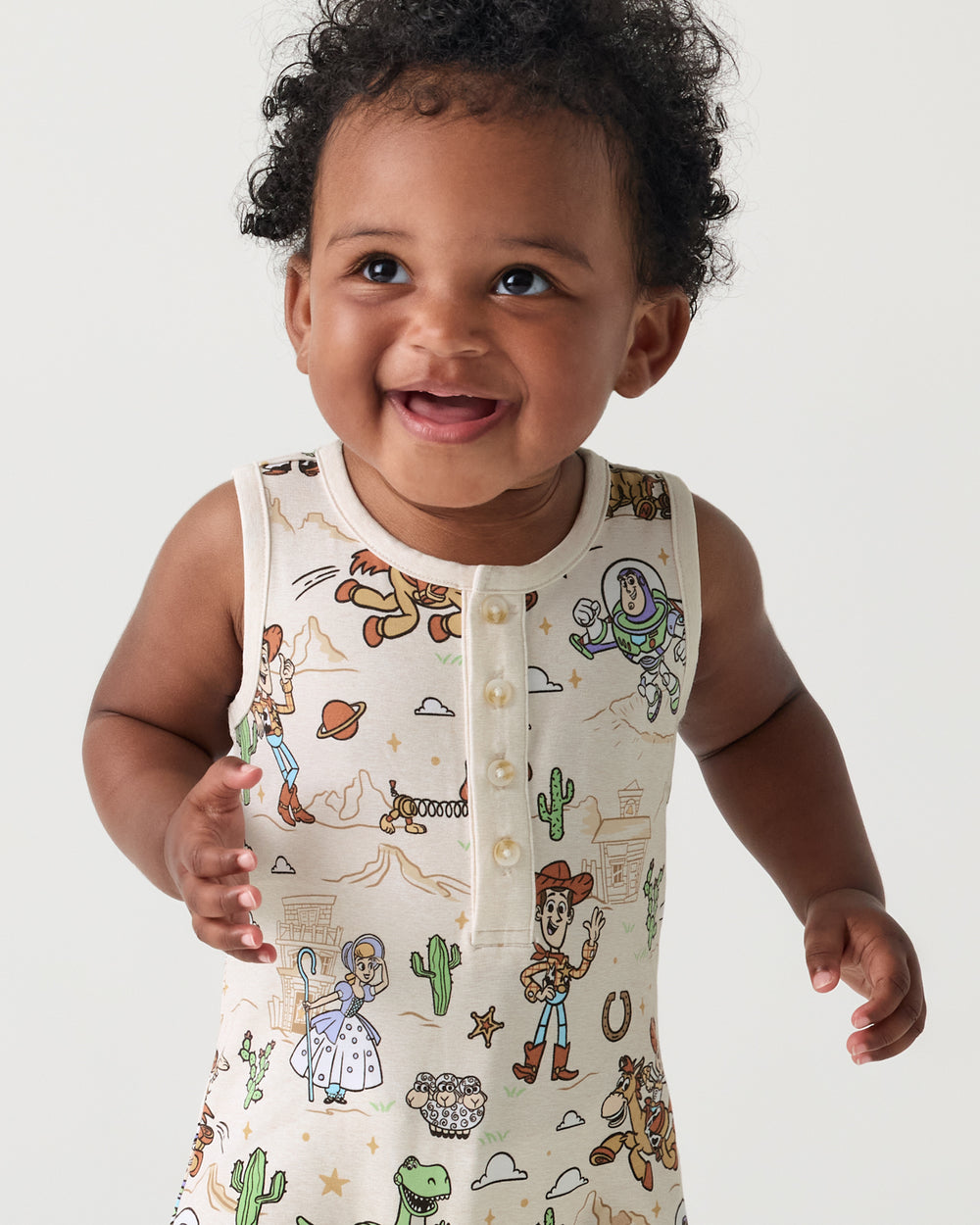 Close up of baby wearing the Disney & Pixar Woody's Wild West Henley Romper