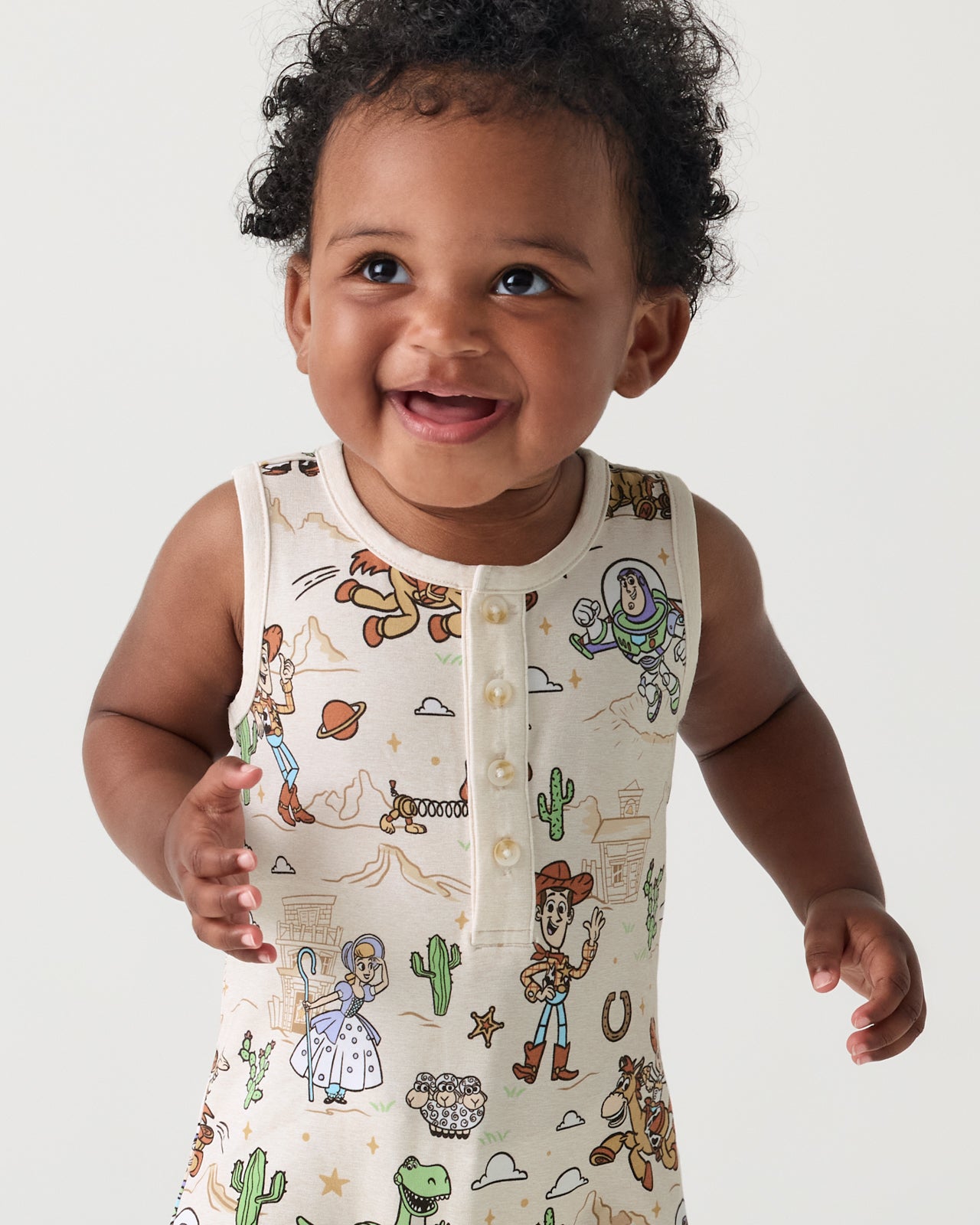 Close up of baby wearing the Disney & Pixar Woody's Wild West Henley Romper