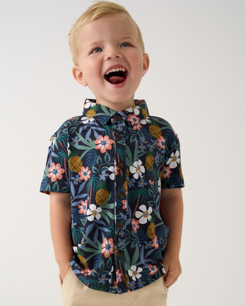 Close up of boy wearing the Tropical Garden Button Down Polo