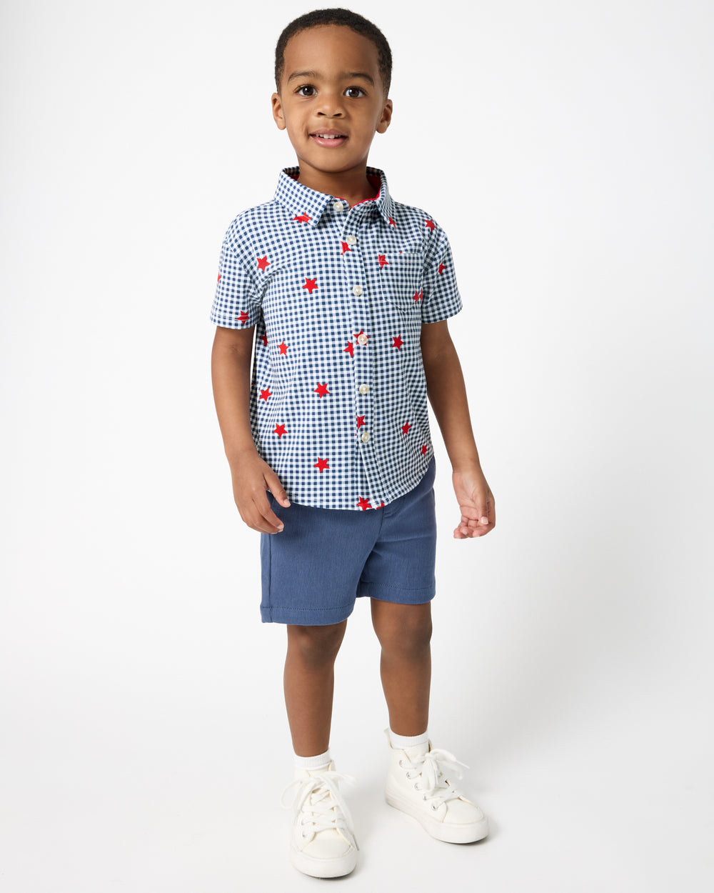 Child wearing navy shorts with the Blue Ribbon Gingham Button Down Shirt