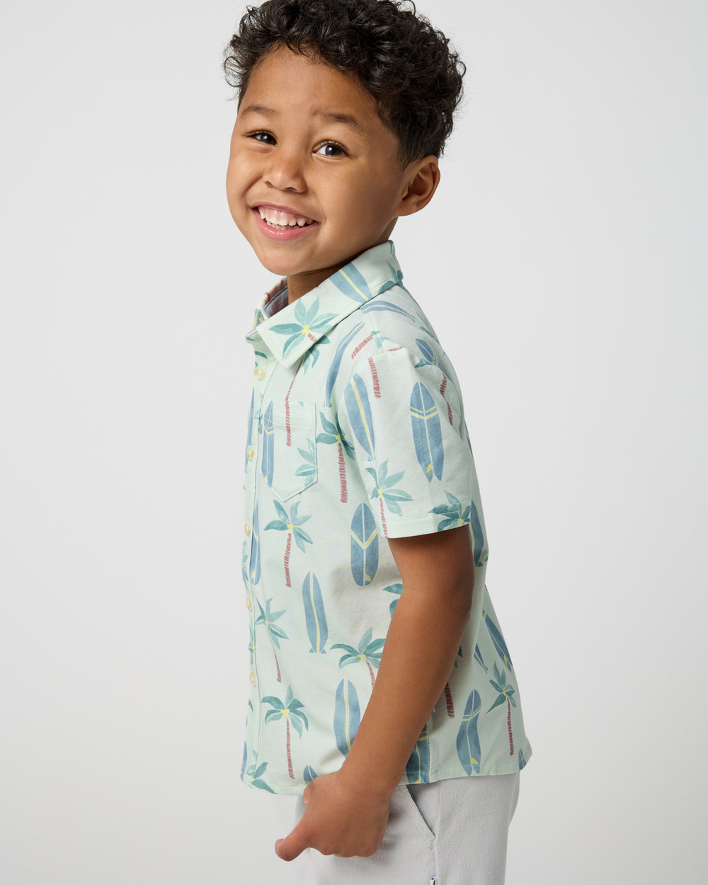 Close up of boy wearing the Palm Dunes Button Down Polo
