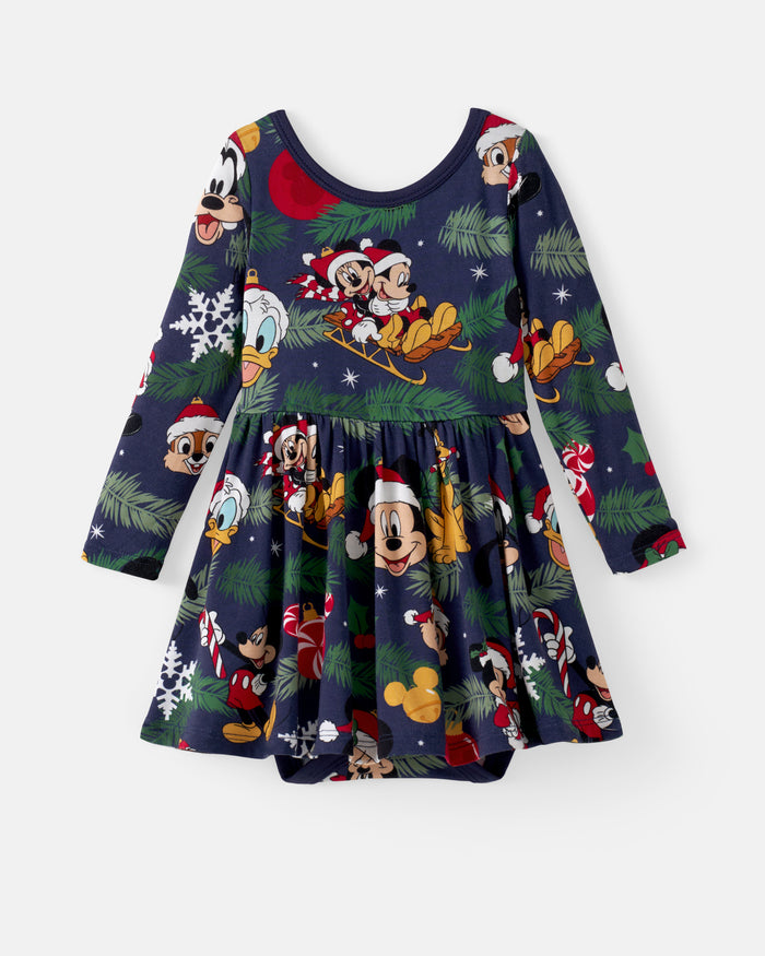 A long-sleeve children's dress with a festive Christmas print featuring Mickey Mouse, Donald Duck, Goofy, and Pluto in Santa hats, set against a dark navy background with pine trees and snowflakes.