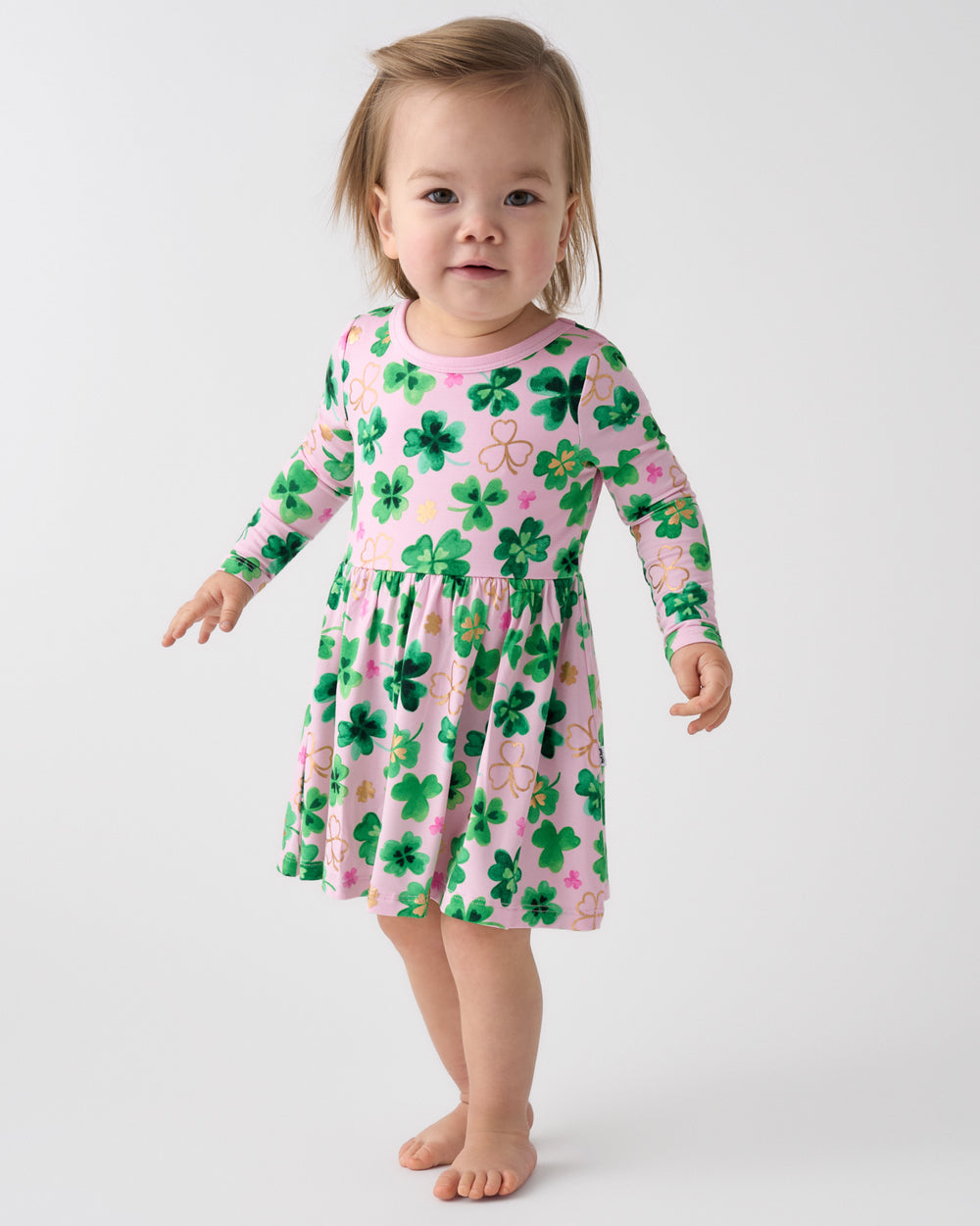 Toddler wearing the Clover Cuties Twirl Dress with Bodysuit