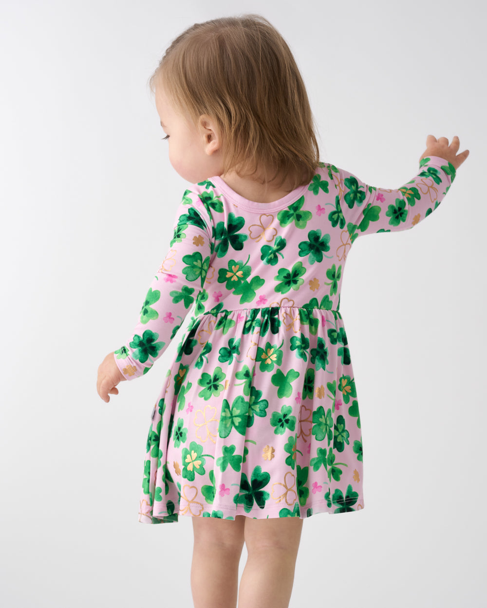 Back view of toddler wearing the Clover Cuties Twirl Dress with Bodysuit