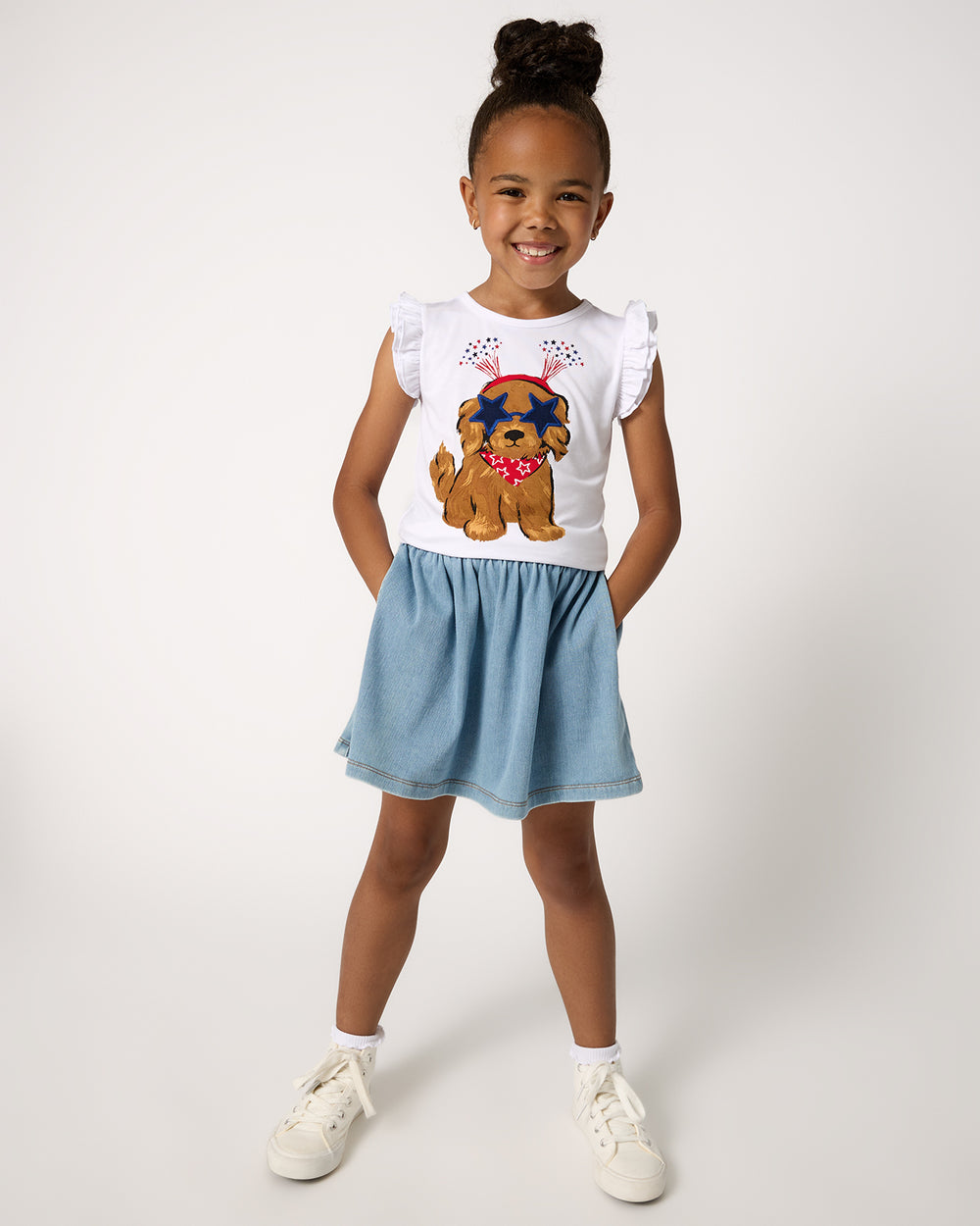 Girl wearing the Star Spangled Pup Flutter Tee with a denim skirt