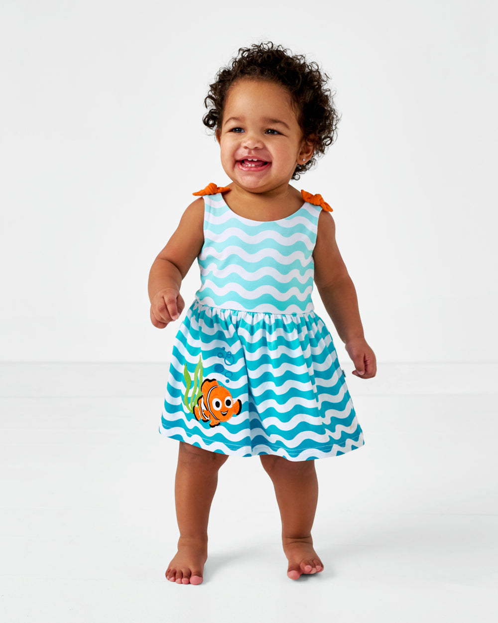 Walking toddler wearing the Nemo Skater Dress with Bodysuit