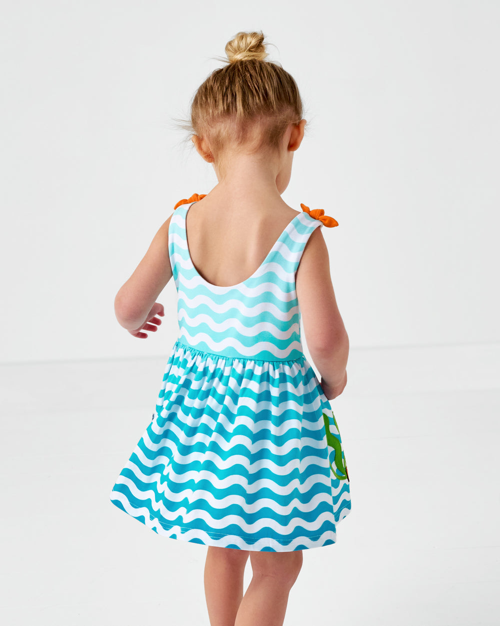 Back view of child wearing the Disney Nemo Skater Dress with Bodysuit