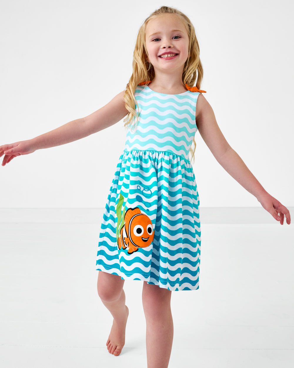 Walking child wearing the Disney Nemo Skater Dress