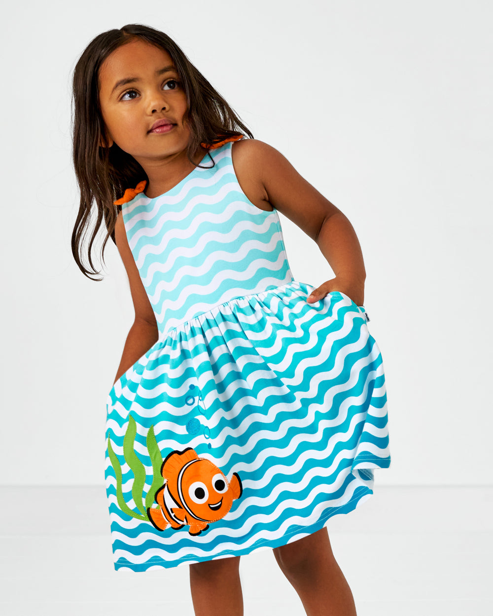 Girl holding out the skirt on the Pixar Nemo Skater Dress