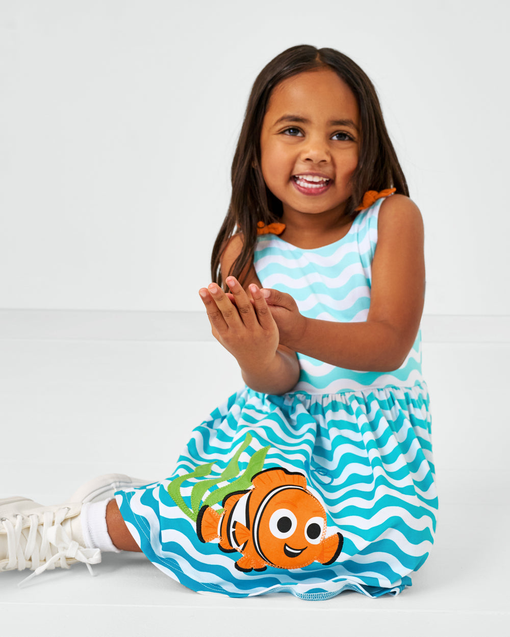 Sitting child wearing the Disney Nemo Skater Dress
