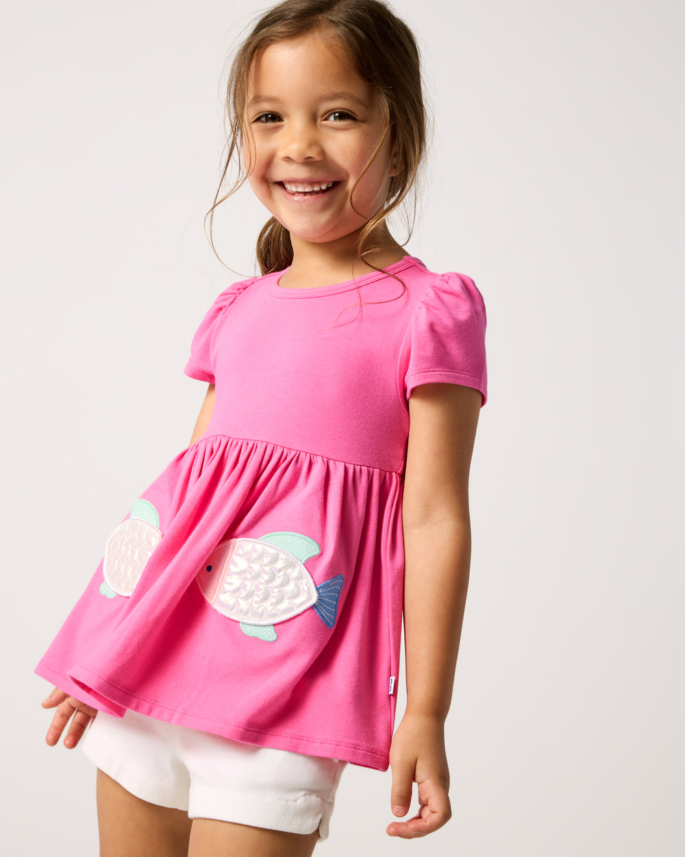 Girl wearing the Sparkling Scales Empire Tunic Top