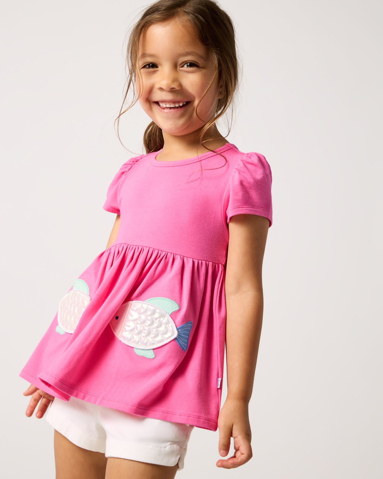Girl wearing the Sparkling Scales Empire Tunic Top