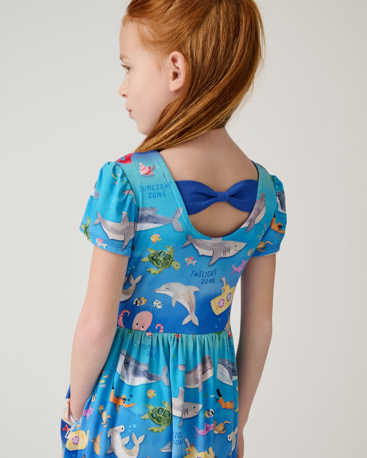 Close up of the bow detail on the Underwater Discovery Bow Back Skater Dress