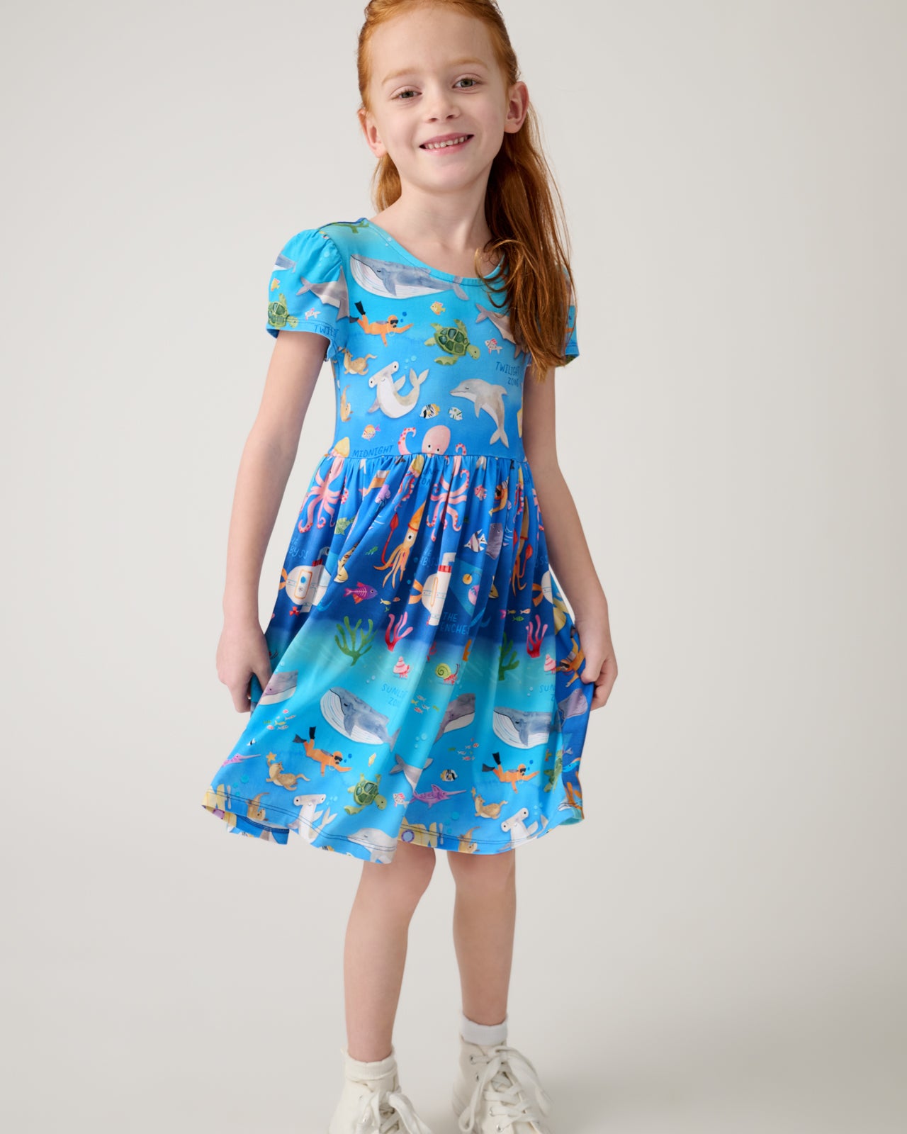 Girl wearing the Underwater Discovery Bow Back Skater Dress