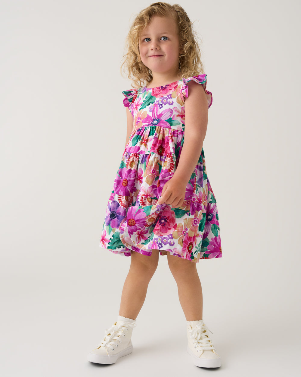 Girl wearing the Hibiscus Blooms Tiered Flutter Dress