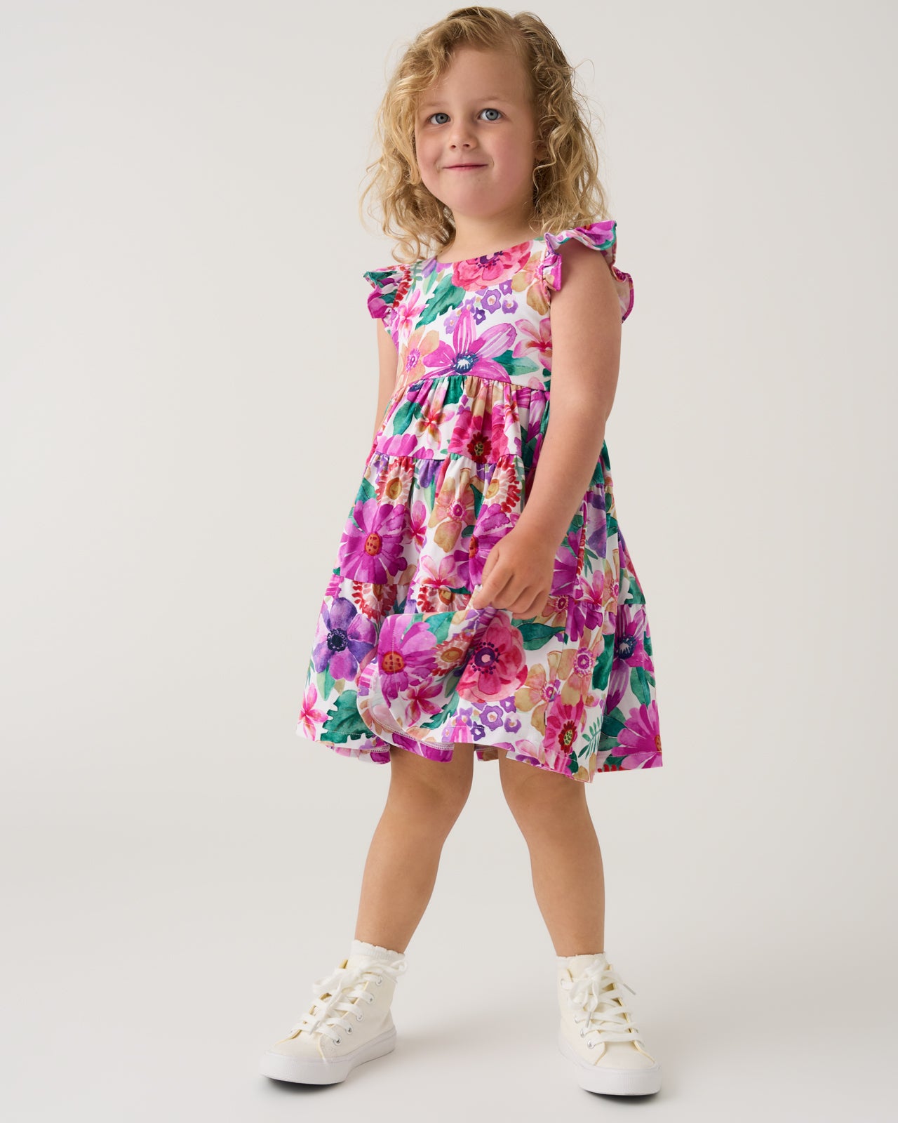Girl wearing the Hibiscus Blooms Tiered Flutter Dress