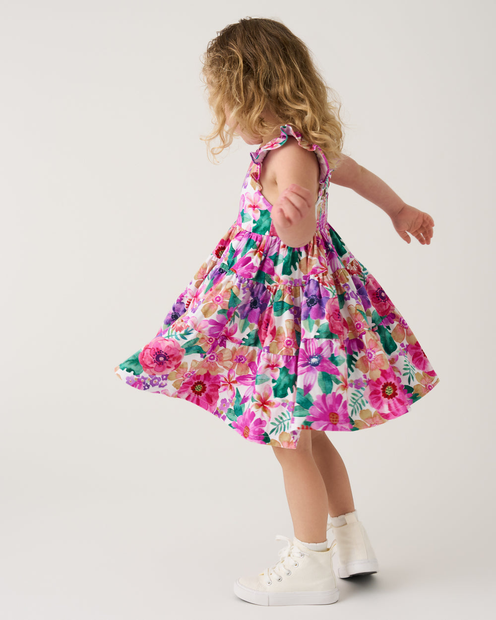 Twirling girl wearing the Hibiscus Blooms Tiered Flutter Dress