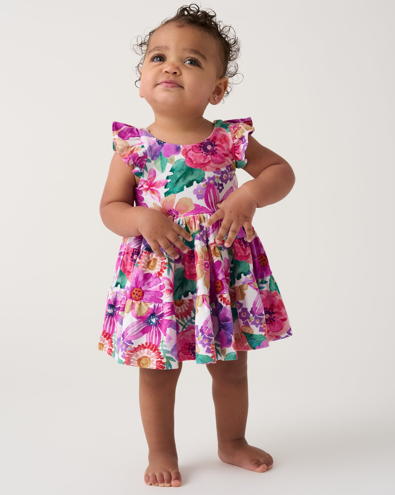 Toddler wearing the Hibiscus Blooms Tiered Flutter Dress with Bloomer