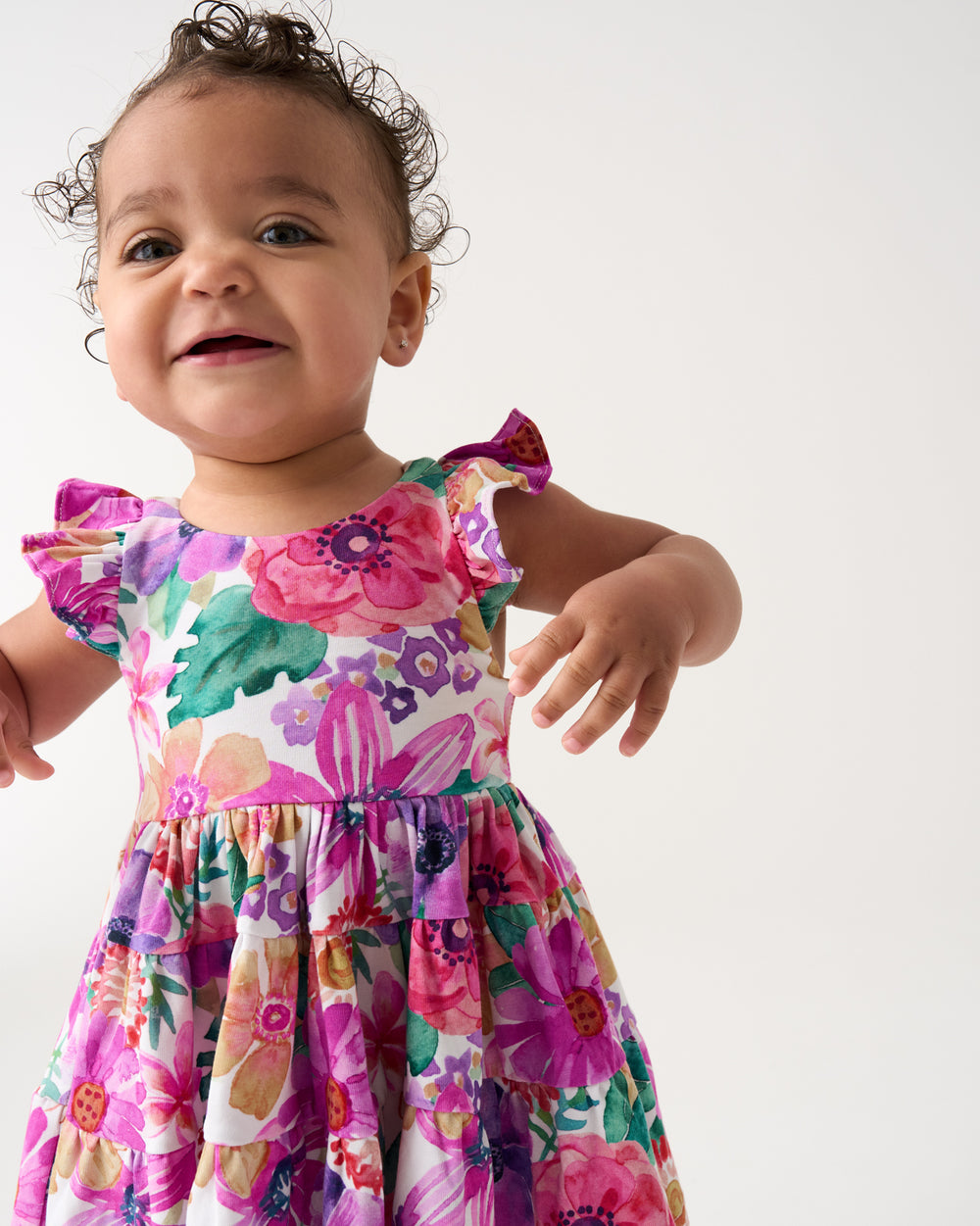 Close up of baby wearing the Hibiscus Blooms Tiered Flutter Dress with Bloomer