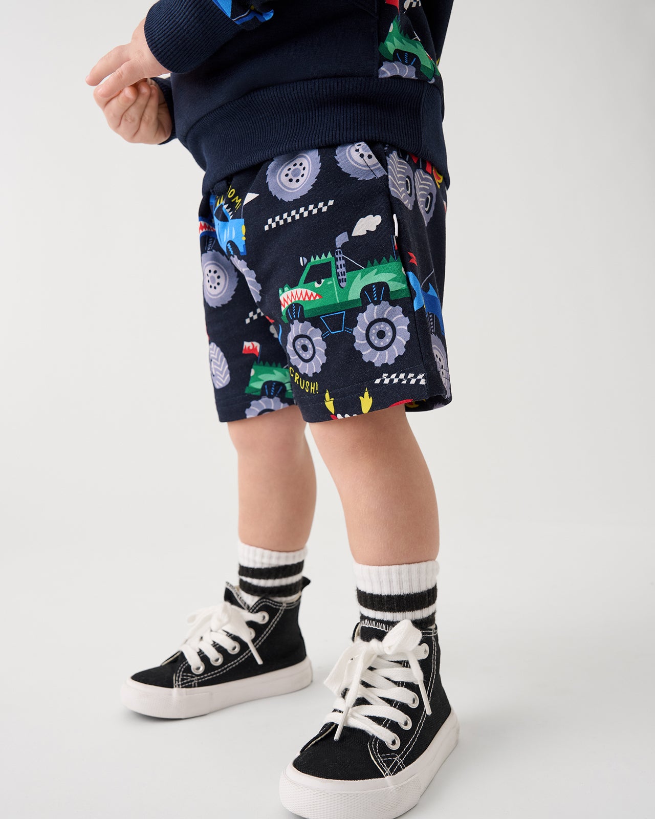 Front view of boy wearing the Monster Truck Madness Drawstring Shorts