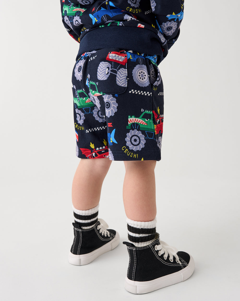 Back view of boy wearing the Monster Truck Madness Drawstring Shorts