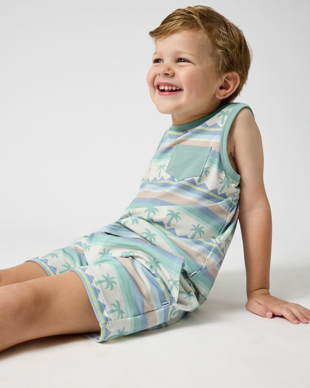 Sitting child wearing the Swell Stripes Drawstring Shorts and Tank