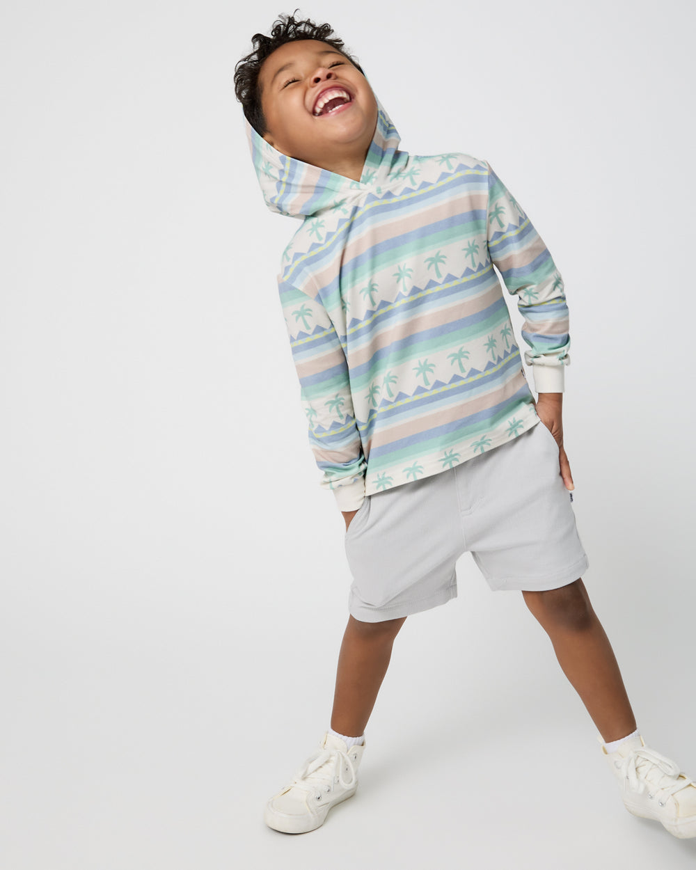 Boy wearing the Swell Stripes Hooded Tee with gray shorts