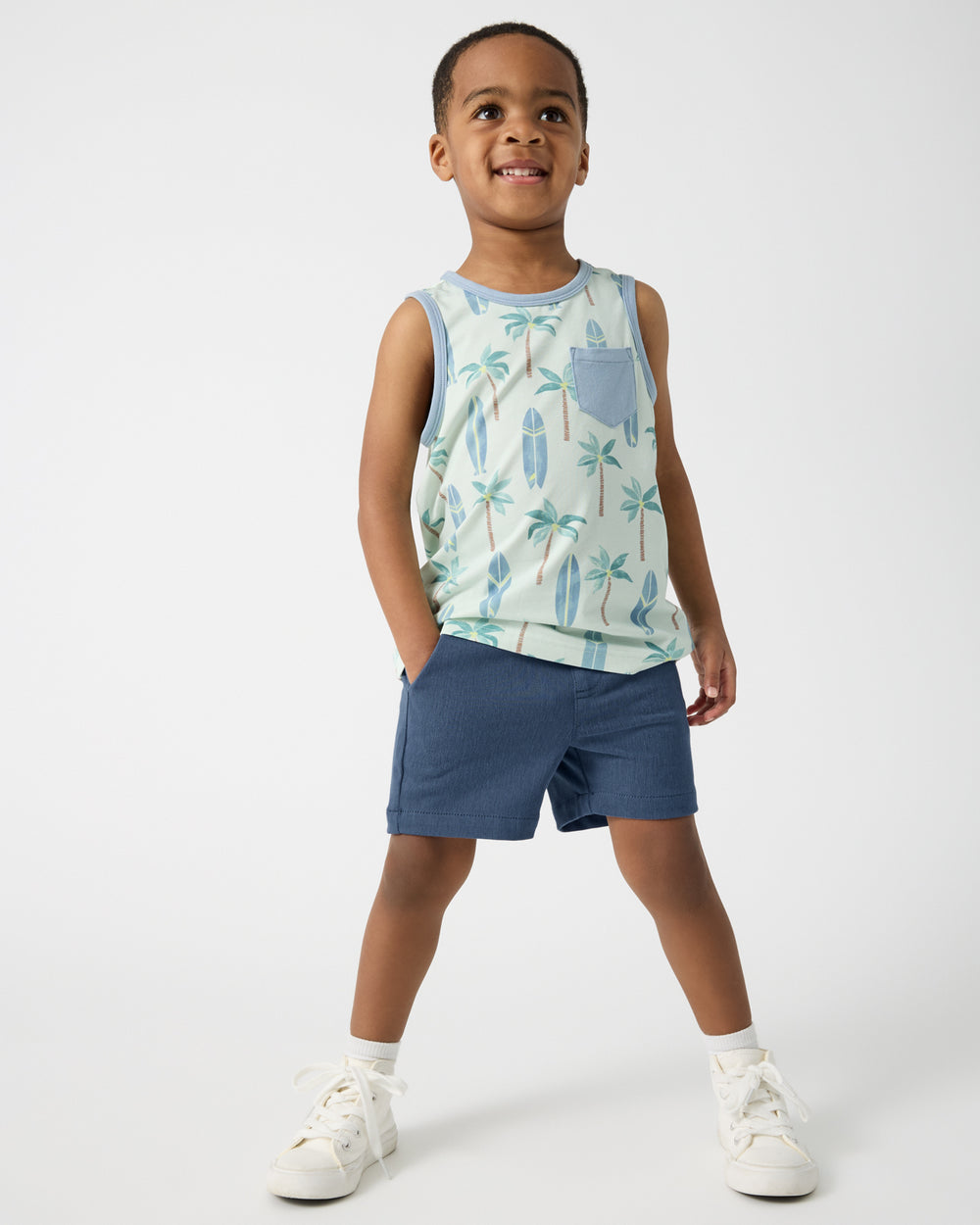 Boy wearing the Palm Dunes Pocket Tank and Navy Shorts