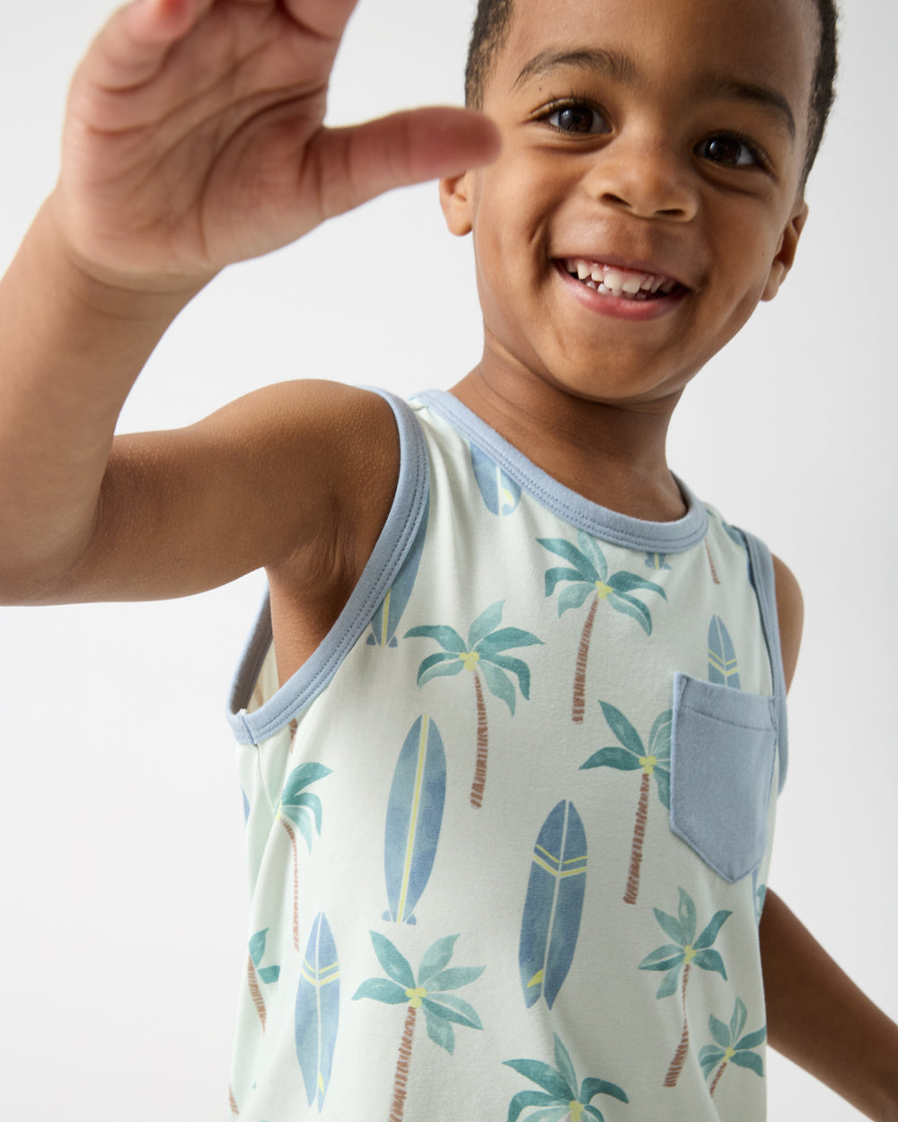 Close up of boy wearing the Palm Dunes Pocket Tank