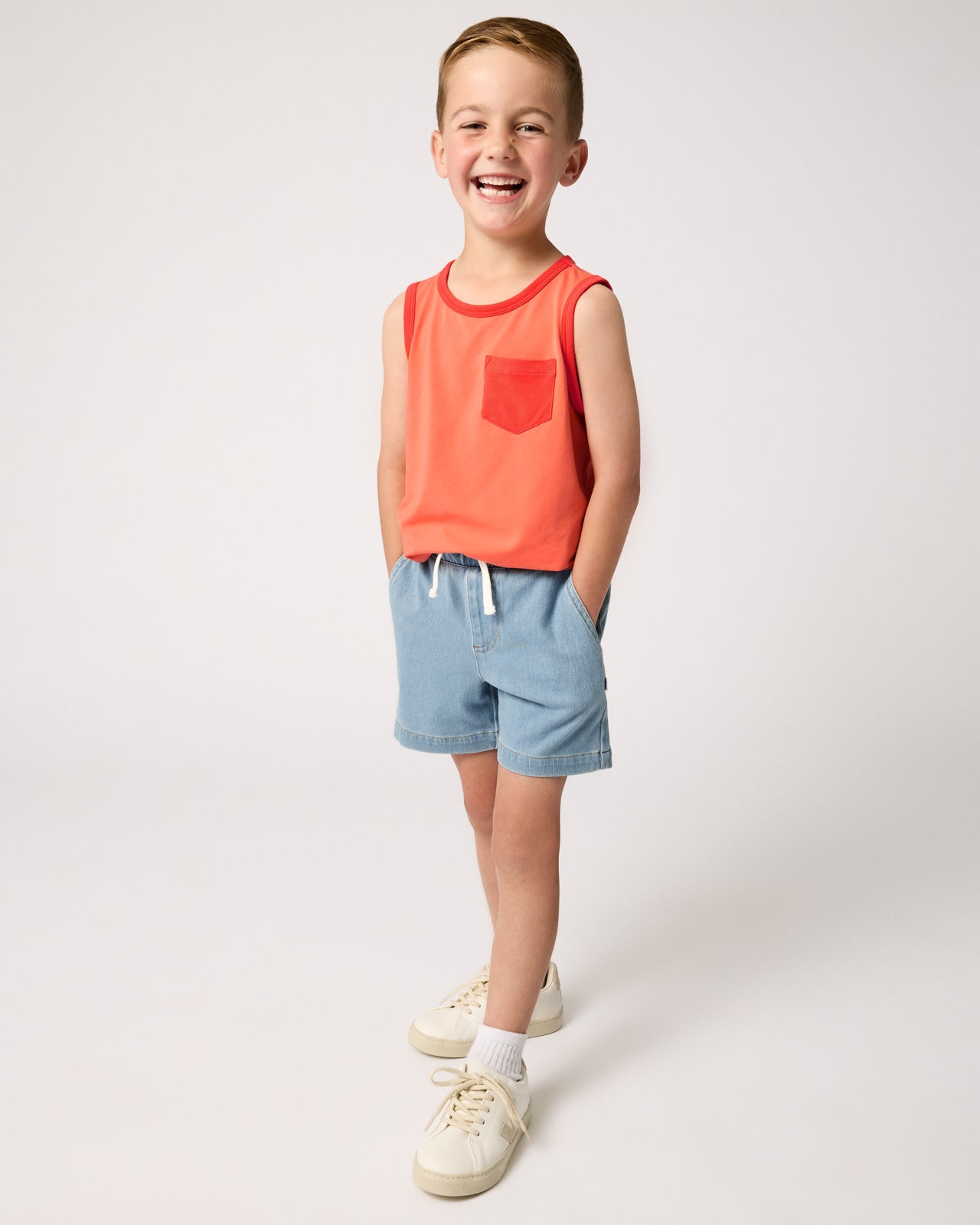 Boy wearing the Orange Crush Pocket Tank with denim boys shorts