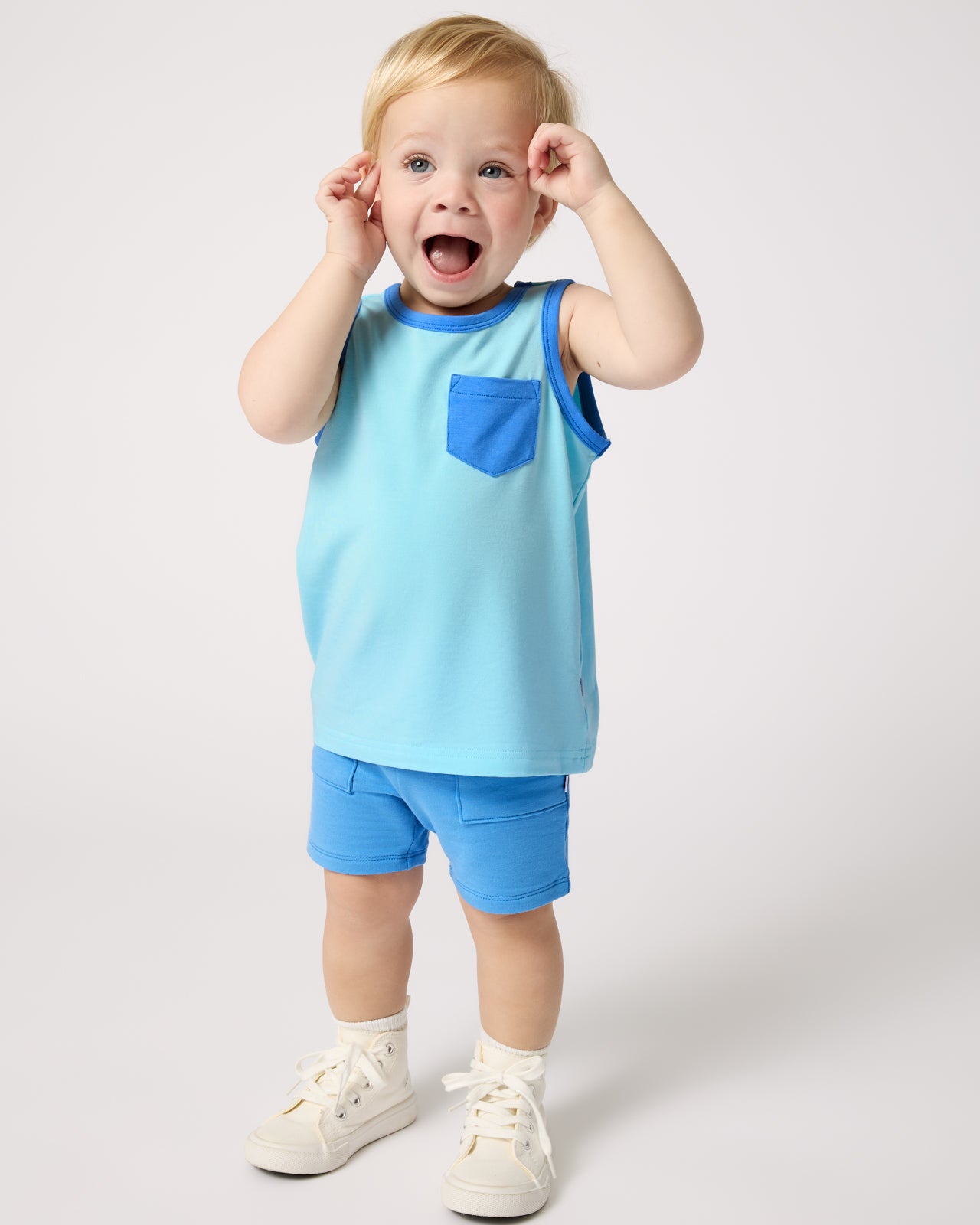 Toddler wearing the Coastal Blue Pocket Tank and Blue Bolt Shorts