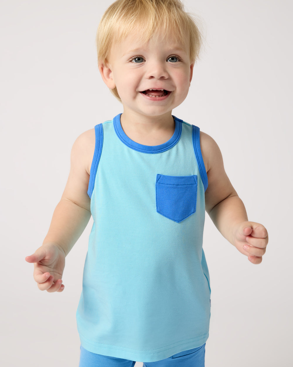 Close up of boy wearing the Coastal Blue Pocket Tank