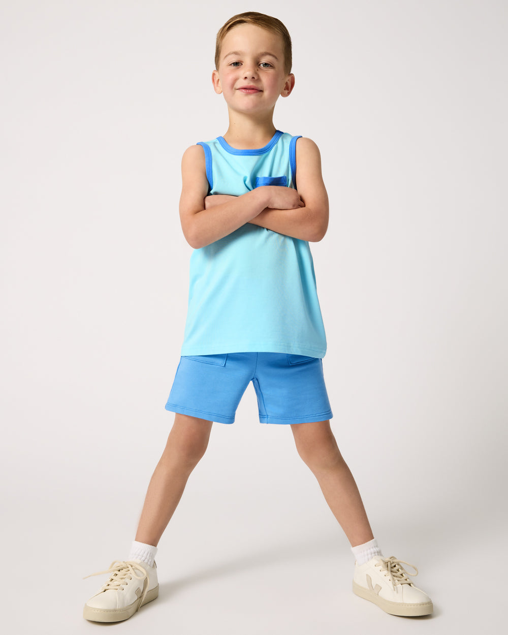 Boy wearing the Coastal Blue Pocket Tank and Blue Boys Shorts