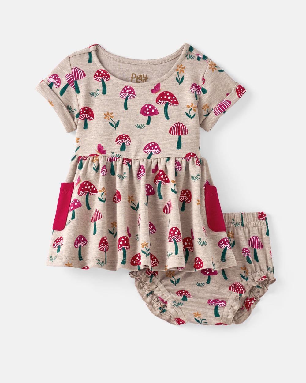 A baby girl's two-piece outfit set featuring a short-sleeve dress and matching bloomers. The set is in a light beige/cream color with an all-over print of red and pink mushrooms, green stems, and small yellow flowers.