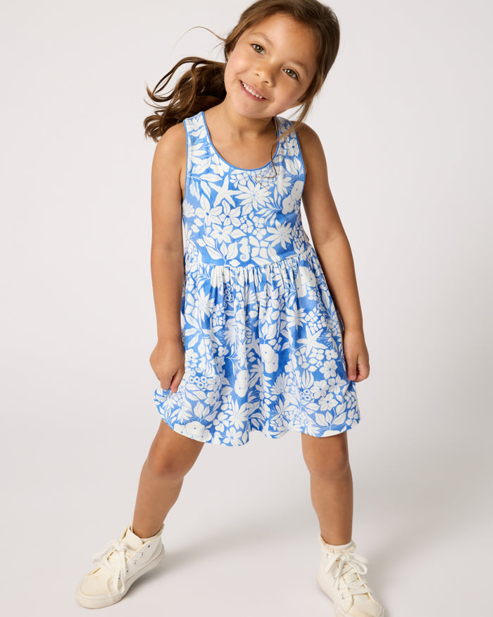 Girl wearing the Azure Garden Cross Back Skater Dress with white sneakers