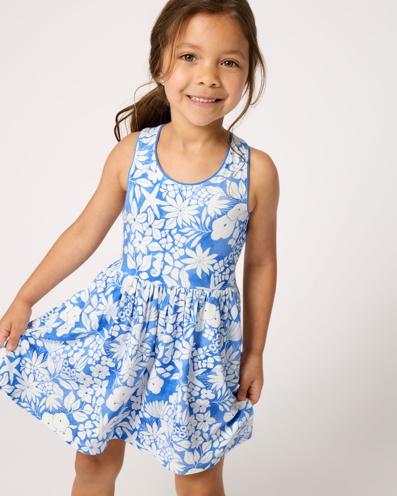 Close up of girl wearing the Azure Garden Cross Back Skater Dress