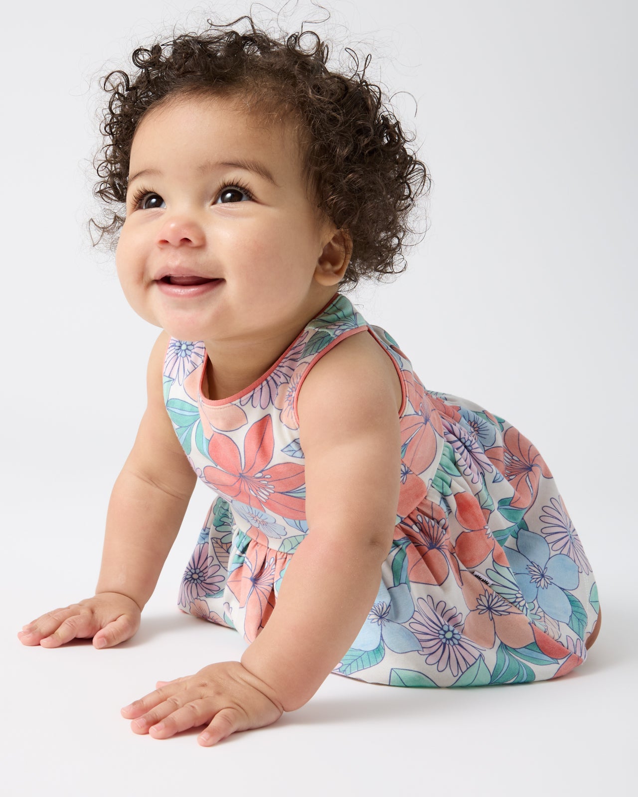Crawling baby wearing the Shoreline Blooms Cross Back Skater Dress with Bloomer
