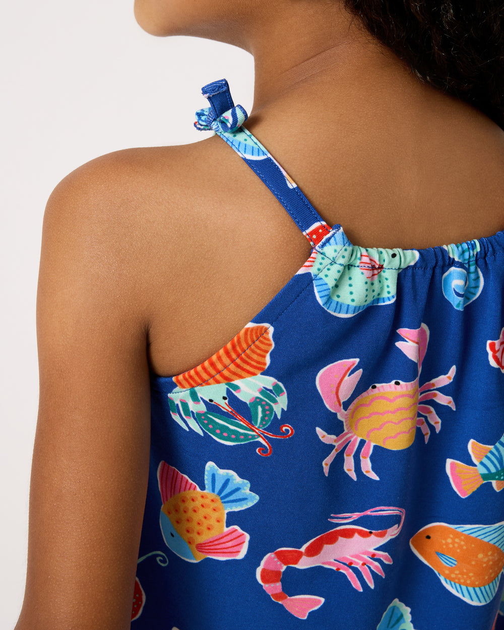 Close up of the strap detail on the Tidepool Party Bow Strap Tank
