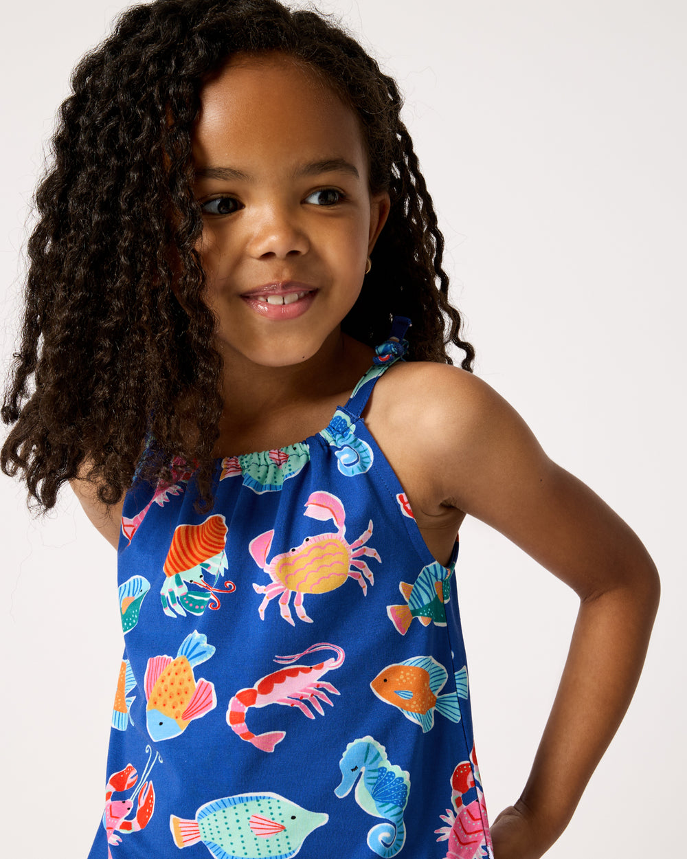 Close up of girl wearing the Tidepool Party Bow Strap Tank