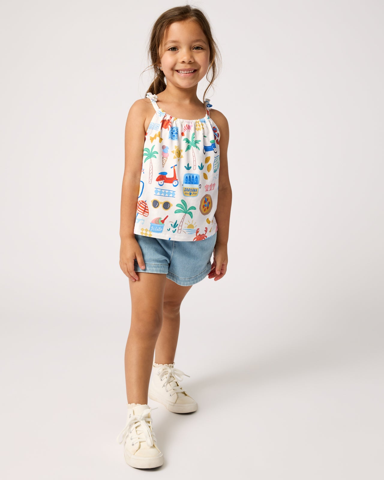 Girl wearing the Ciao Bella Bow Strap Tank with denim shorts