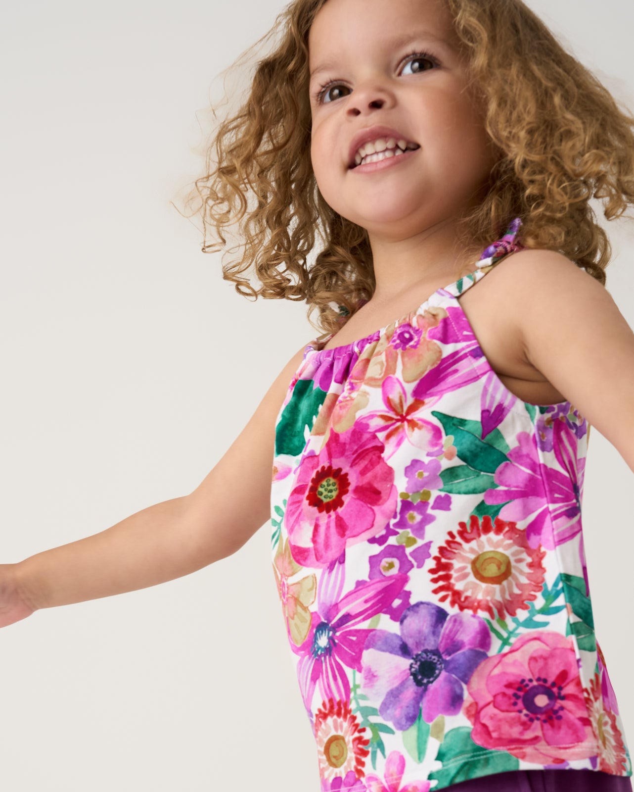 Close up of girl wearing the Hibiscus Blooms Bow Strap Tank