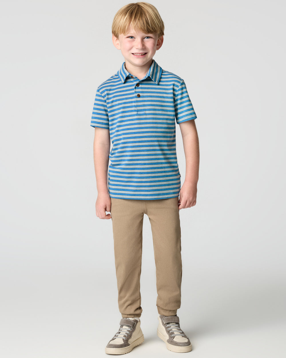 Standing child wearing the Jay Blue Heather Stripes Polo Shirt