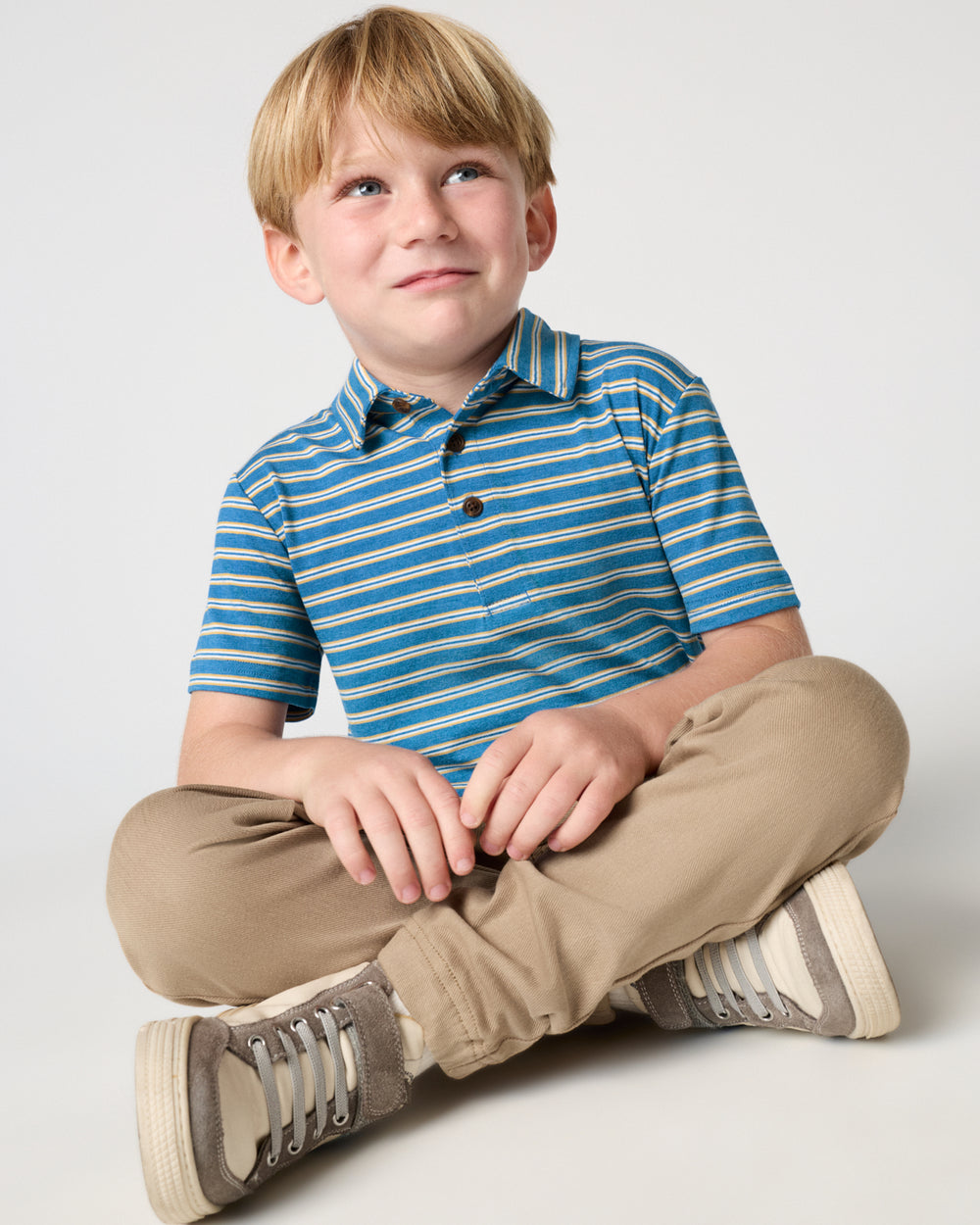 Boy wearing the Jay Blue Heather Stripes Polo Shirt with khaki joggers