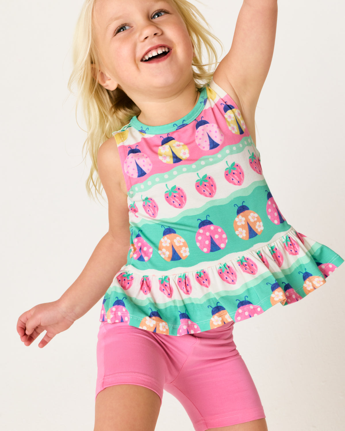 Close up of posing girl wearing the Ladybug Lane Peplum Tank