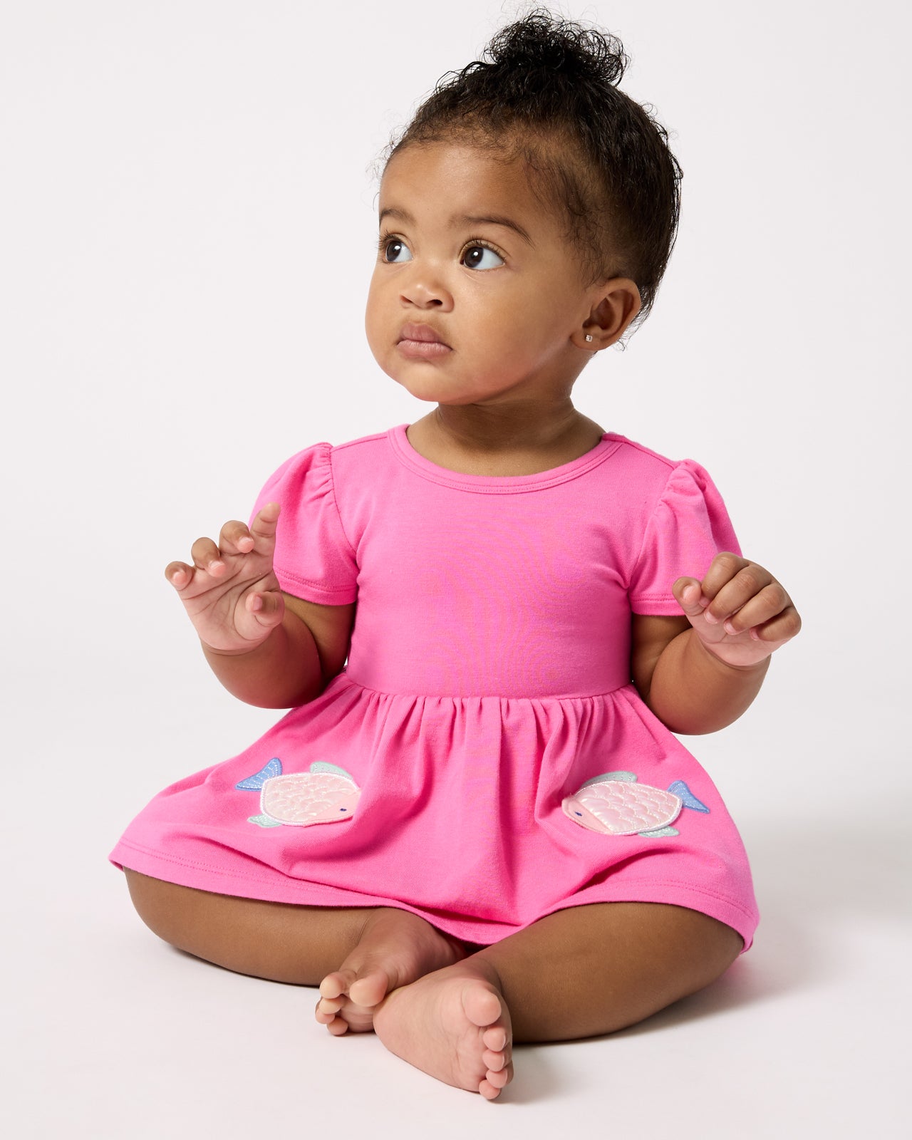 Sitting baby wearing the Sparkling Scales Empire Tunic Top with Bloomer