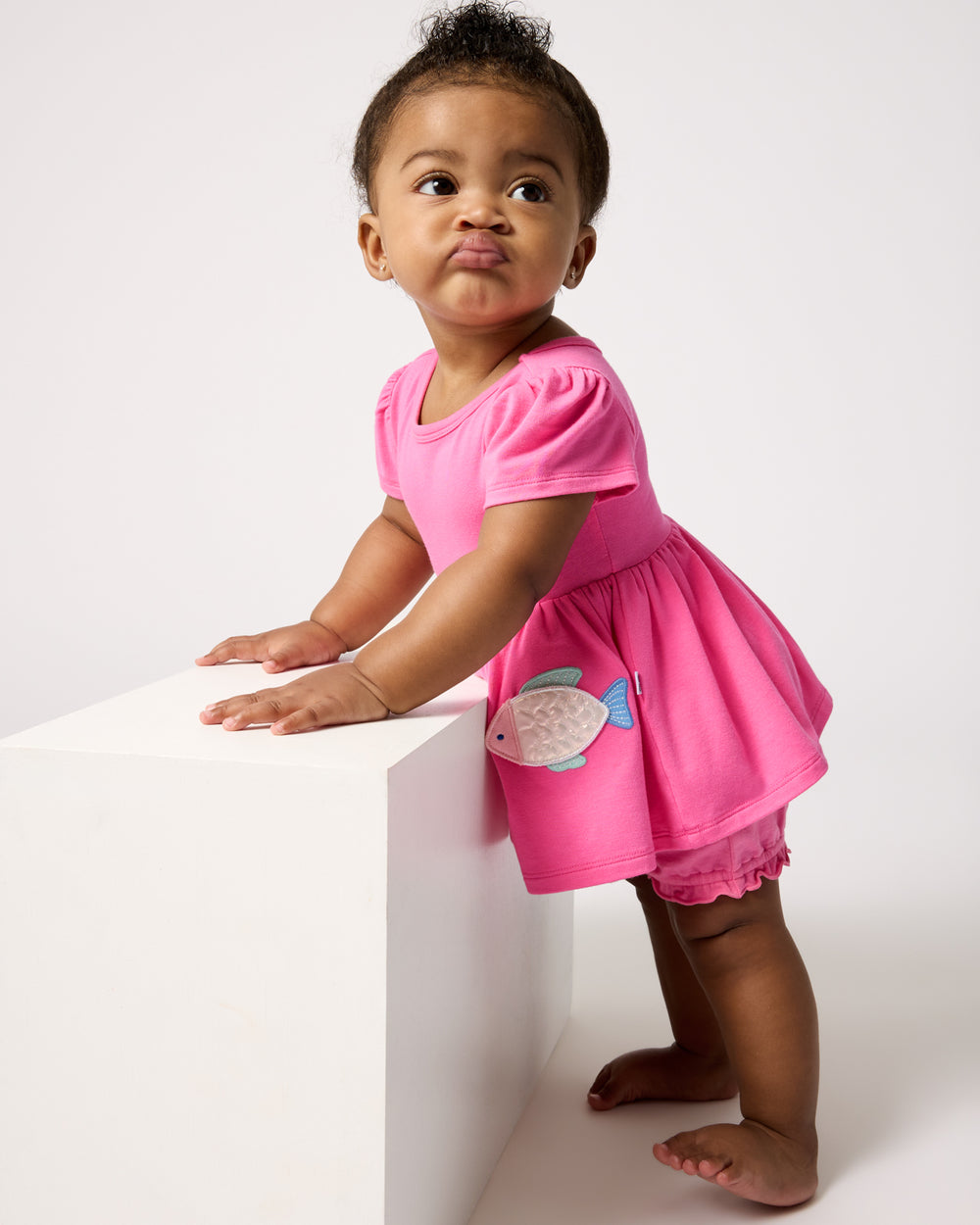 Standing baby wearing the Sparkling Scales Empire Tunic Top with Bloomer
