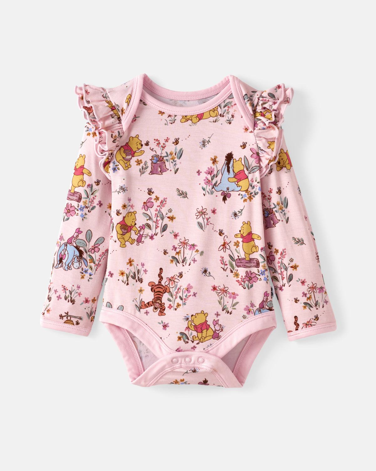 A pink long-sleeve baby bodysuit featuring an all-over Winnie the Pooh and Disney character print, with ruffled shoulder details and snap closures at the crotch and armholes.