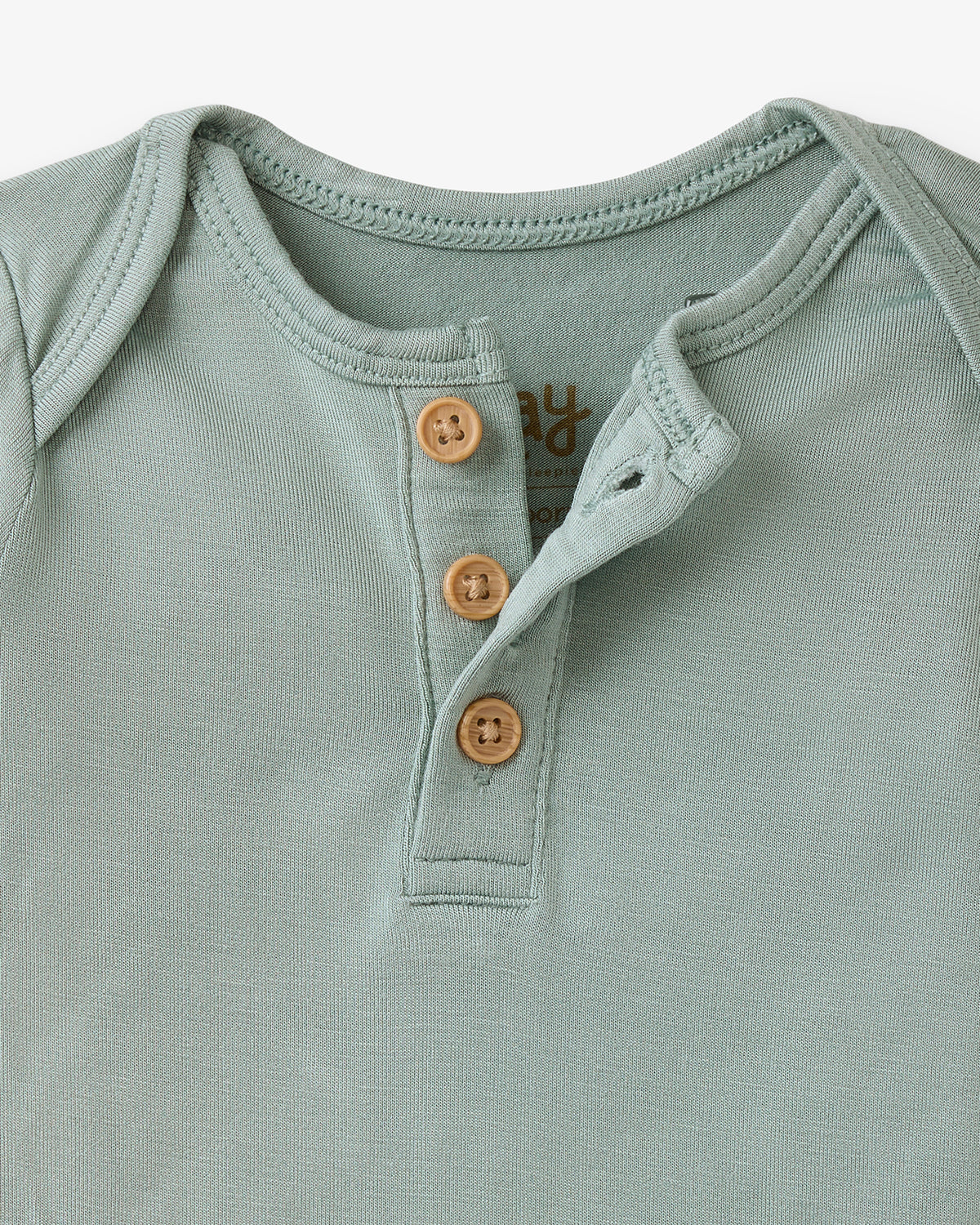 Close up flat lay of the Willow Henley Bodysuit