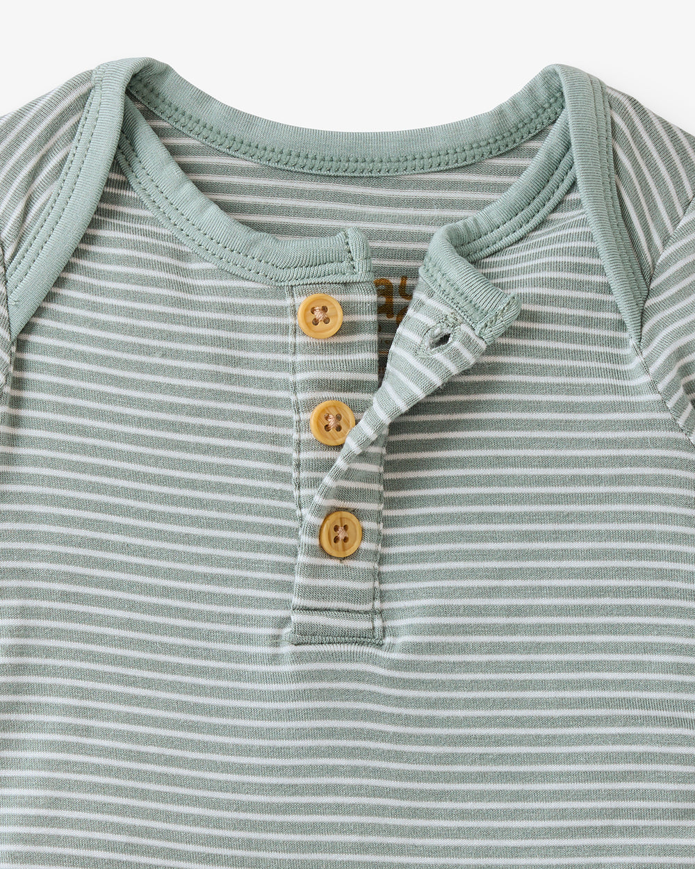 Close up flat lay of the button detail on the Willow Stripe Henley Bodysuit